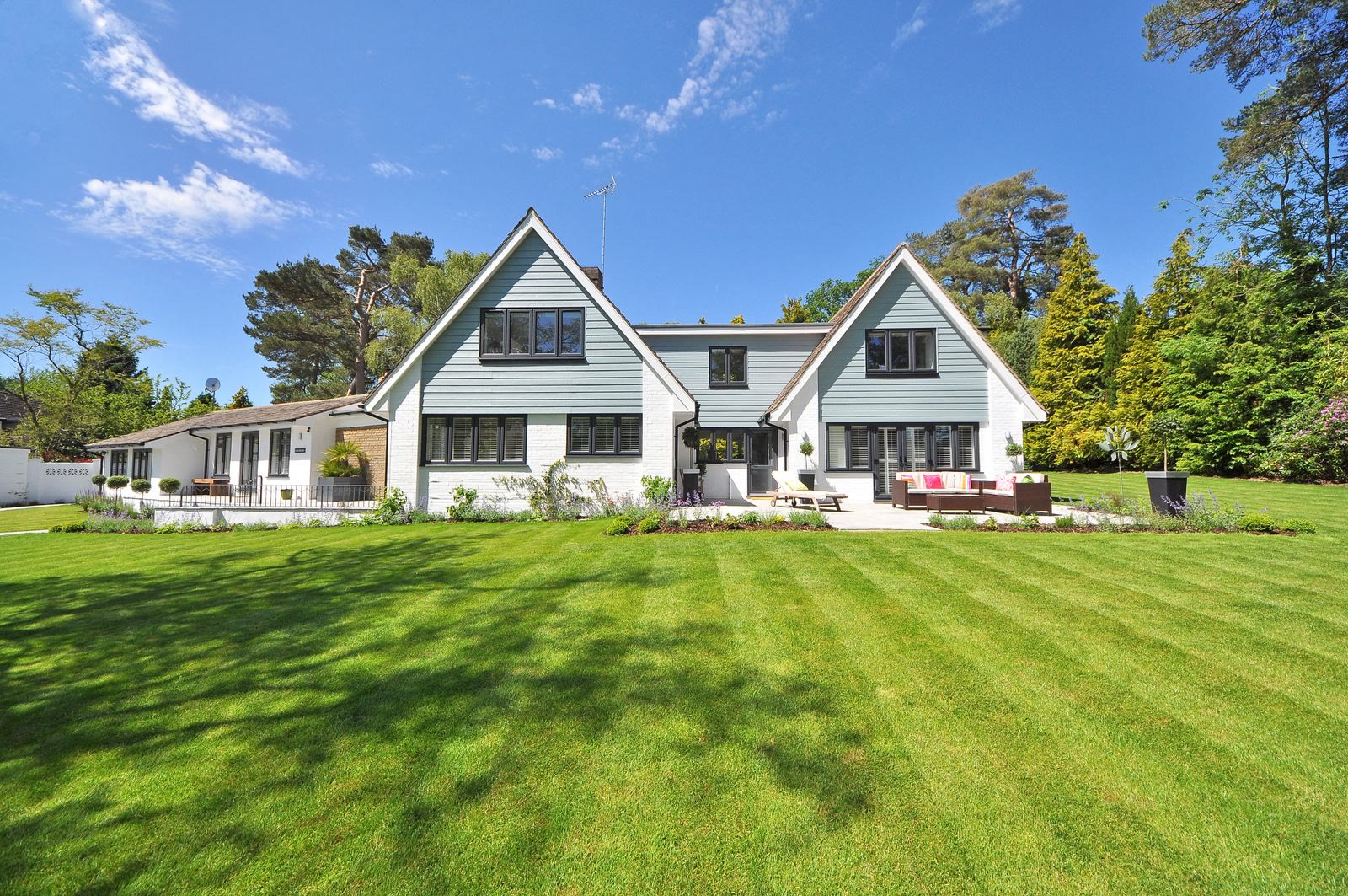 White-brick modern farmhouse suburban home with black-framed windows and dark roof representing Phoenix